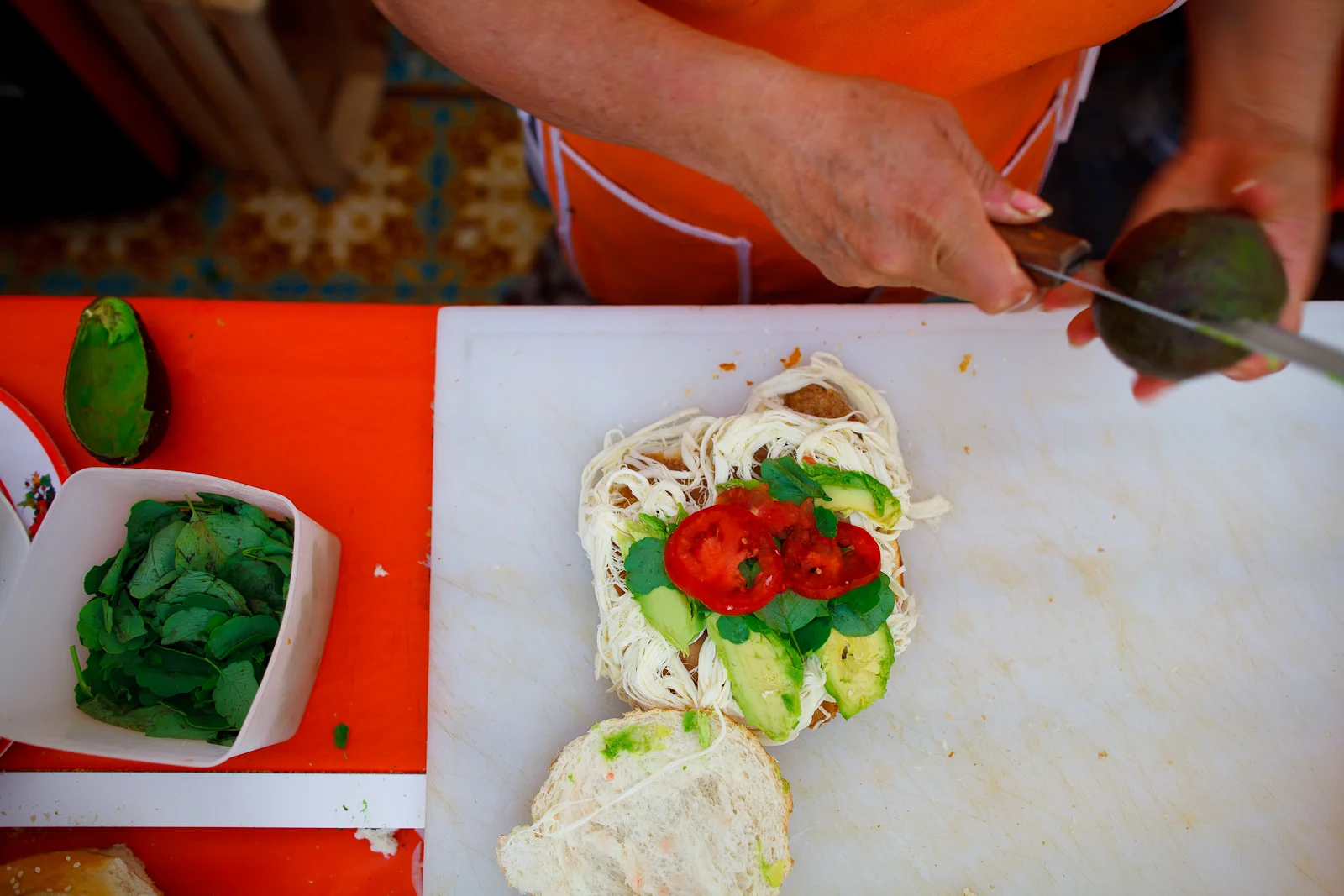 Making a cemita, bowl of pápalo on the left