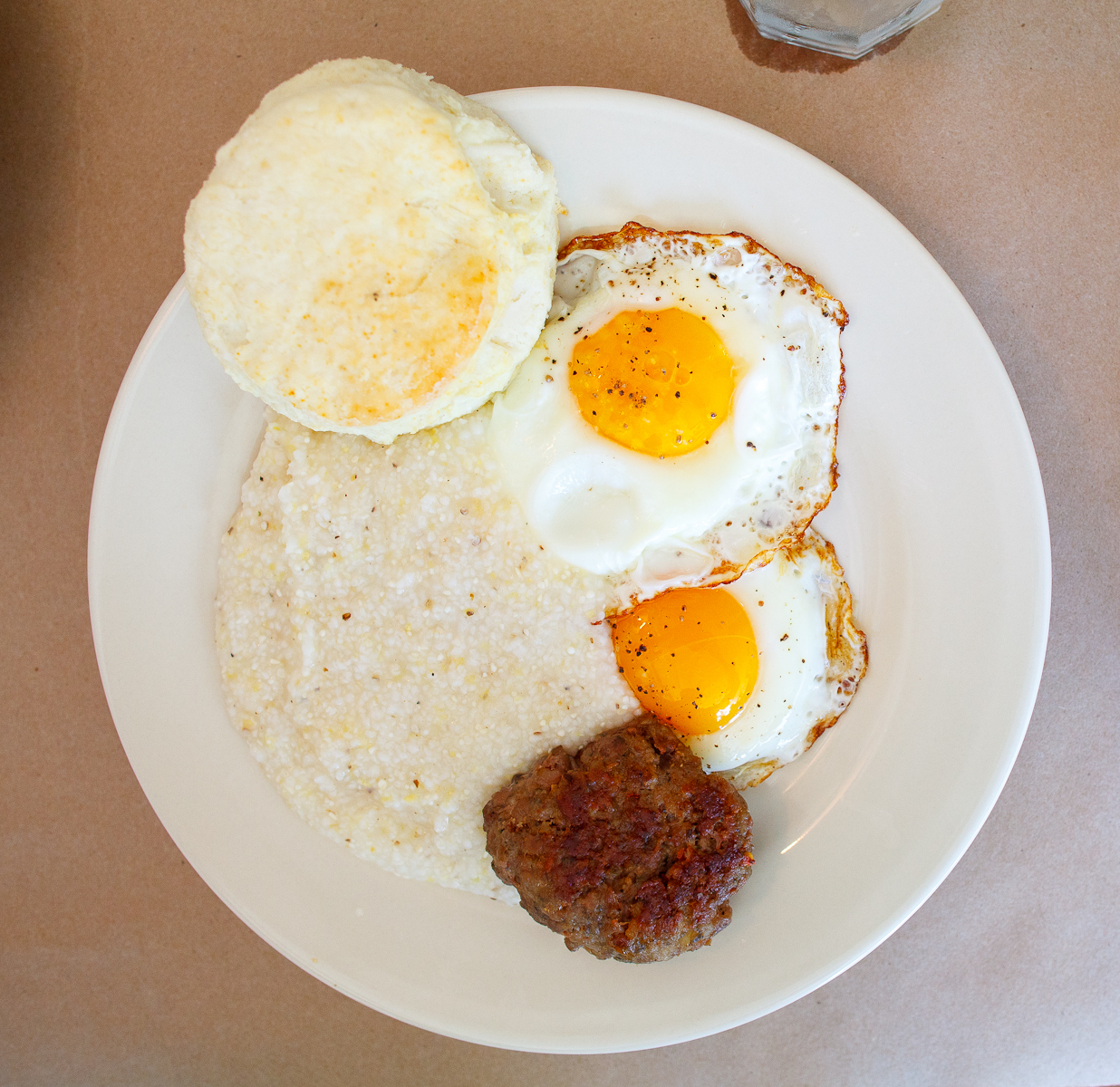 Two eggs sunny side up with Hominy grits and a biscuit ($7)