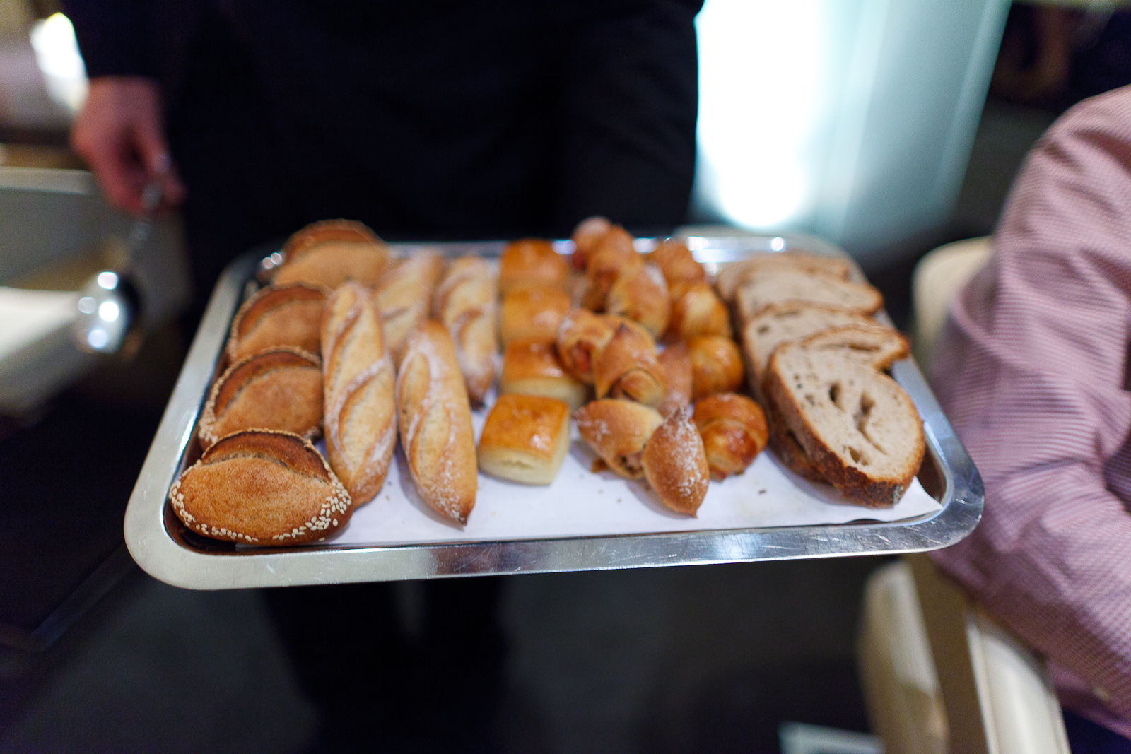 Bread presentation: sesame, baguette, pain au lait, bacon bread, rosemary croissant, sourdough