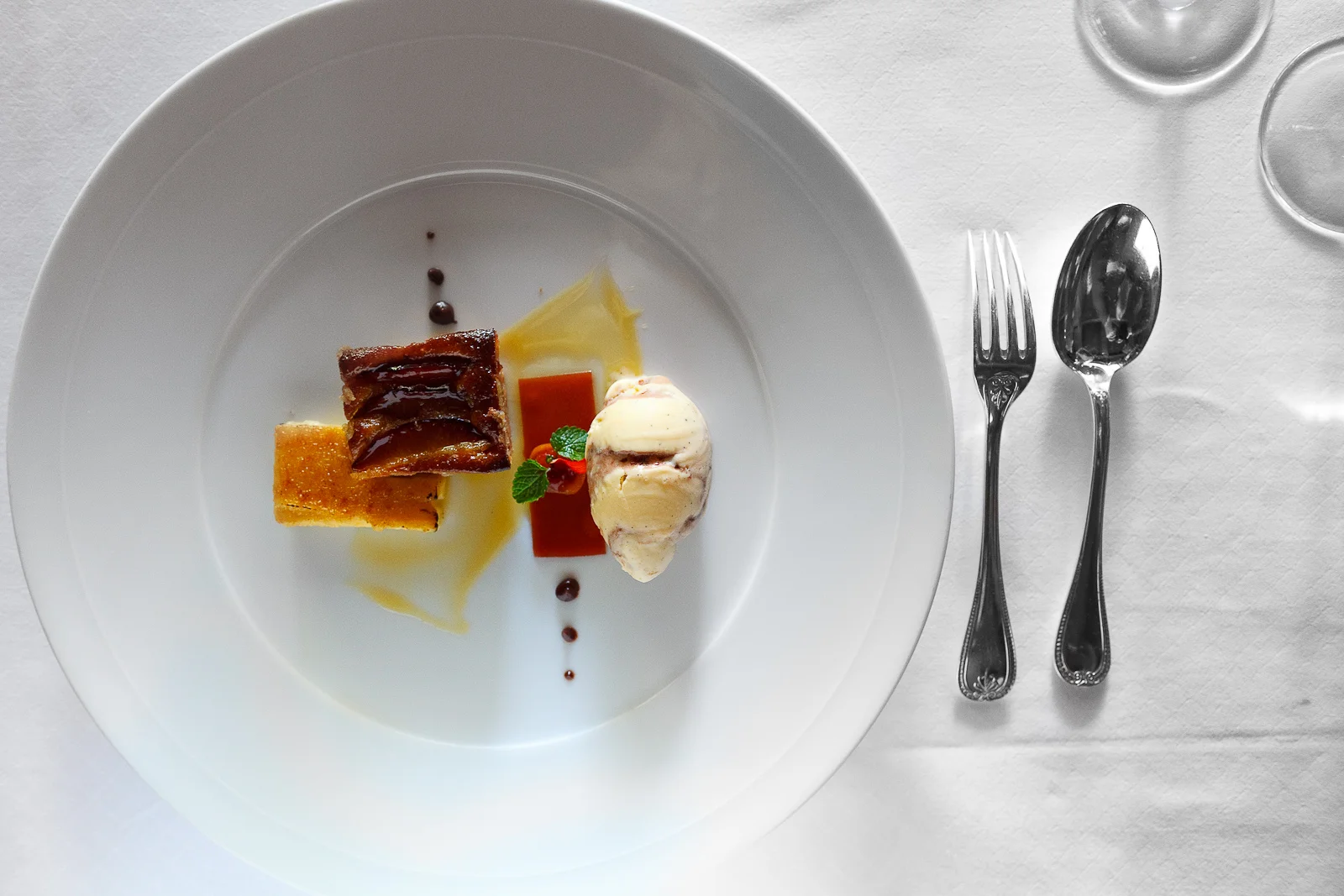 th Course: Gratinated plum taste, orange-honey ice cream