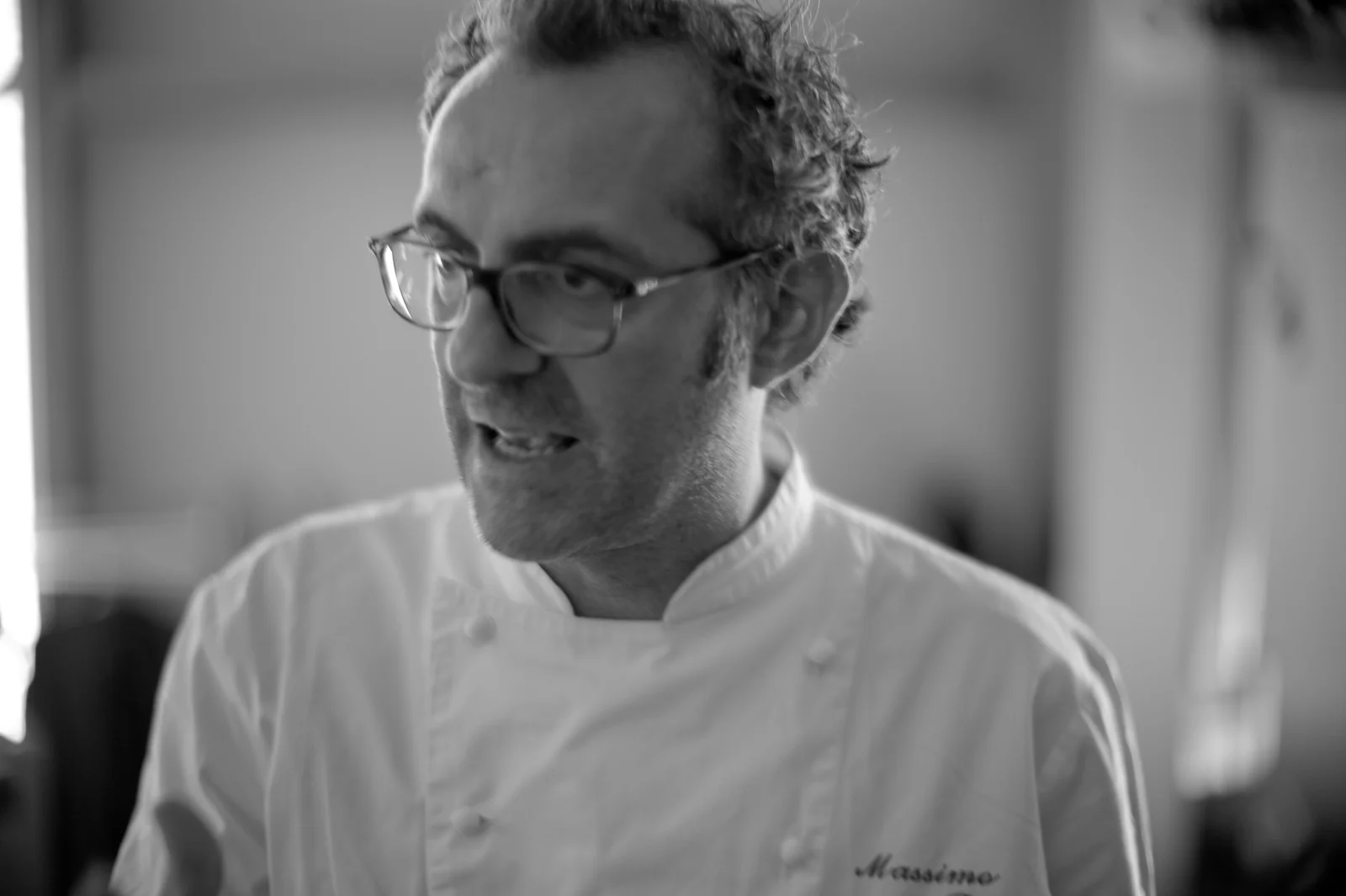 Portrait of Massimo Bottura. "Put down your fork and knife at least once during your meal and touch your food."
