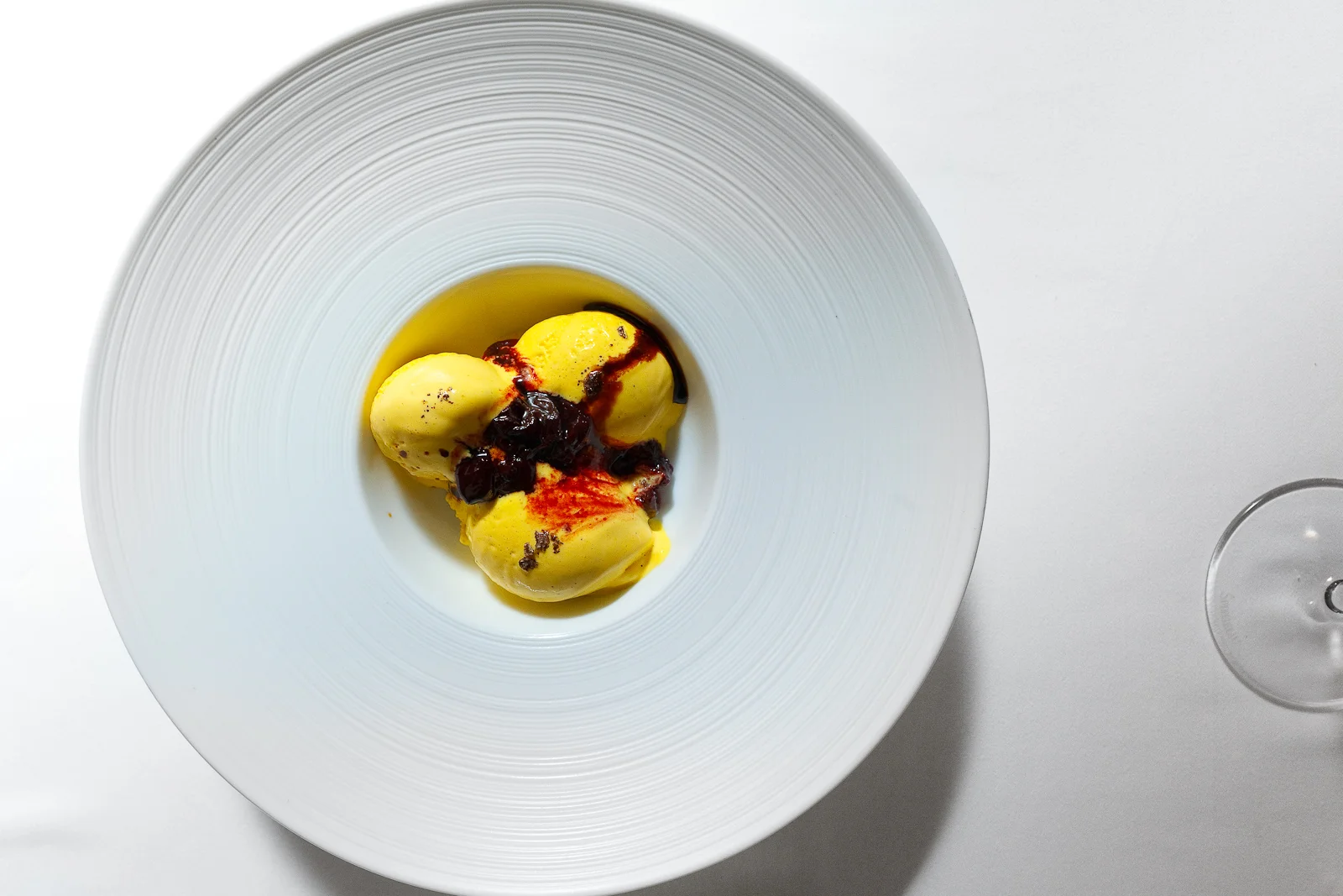 11th Course: Vanilla gelato served with Dr. Levi's sour cherry confit, topped with 80-year old balsamic vinegar from Modena, overhead shot