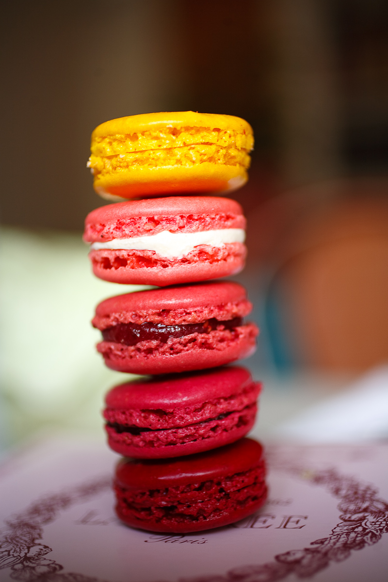 Stack of macarons: black currant, raspberry, red fruits, rose, lemon