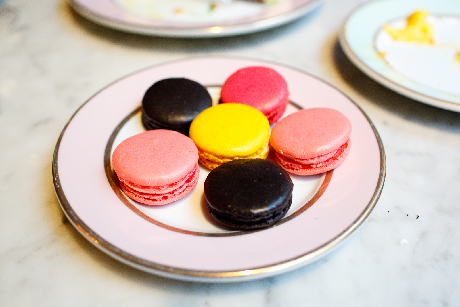 Small plate of macarons: rose, licorice, lemon, raspberry