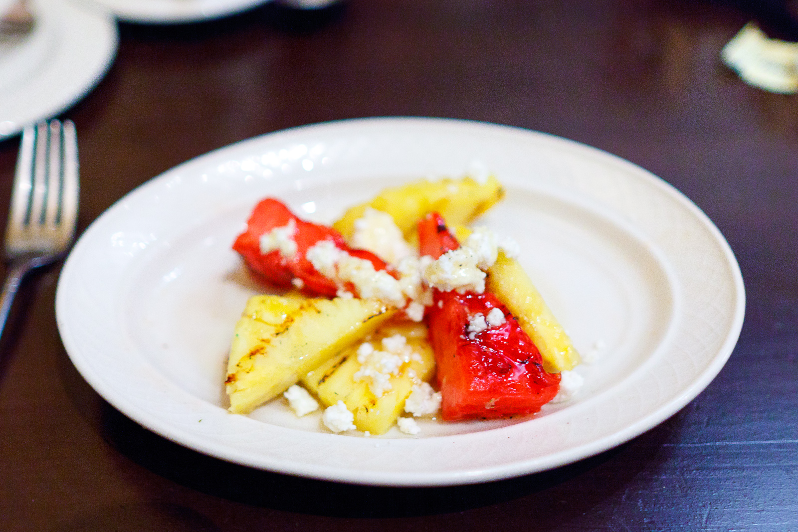 Grilled pineapple and watermelon, feta, honey, crushed pepper ($5)