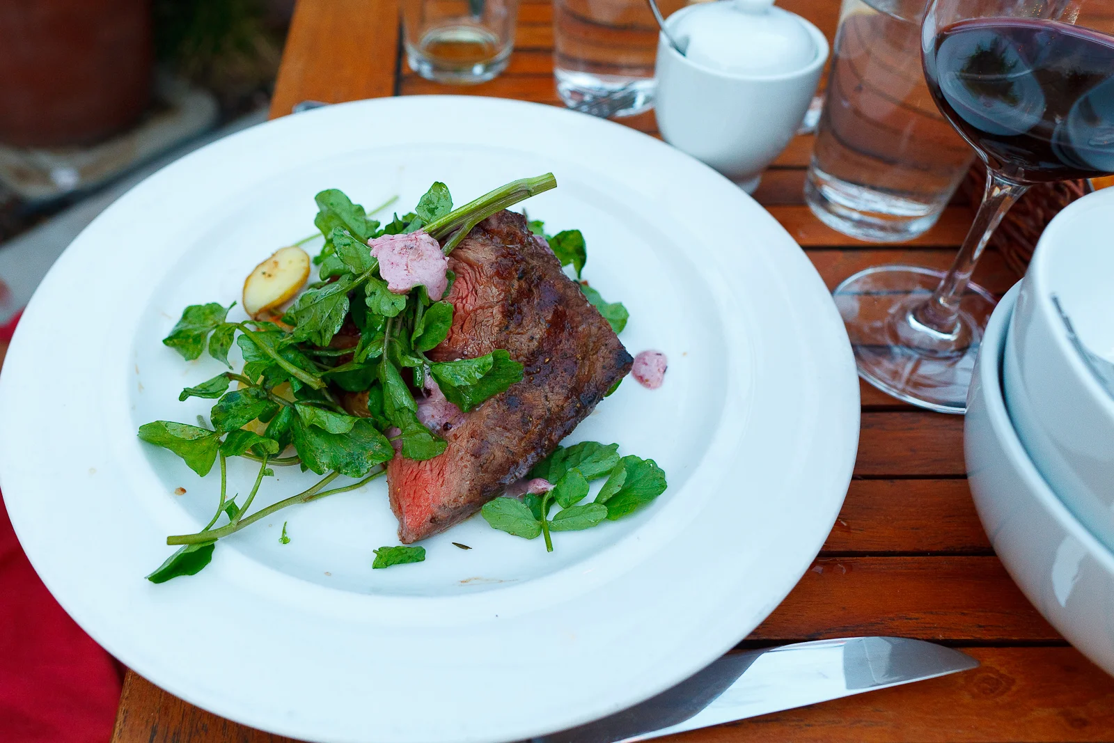 Grilled flat iron steak 8oz, roasted garden potatoes, watercress, bone marrow butter ($24)