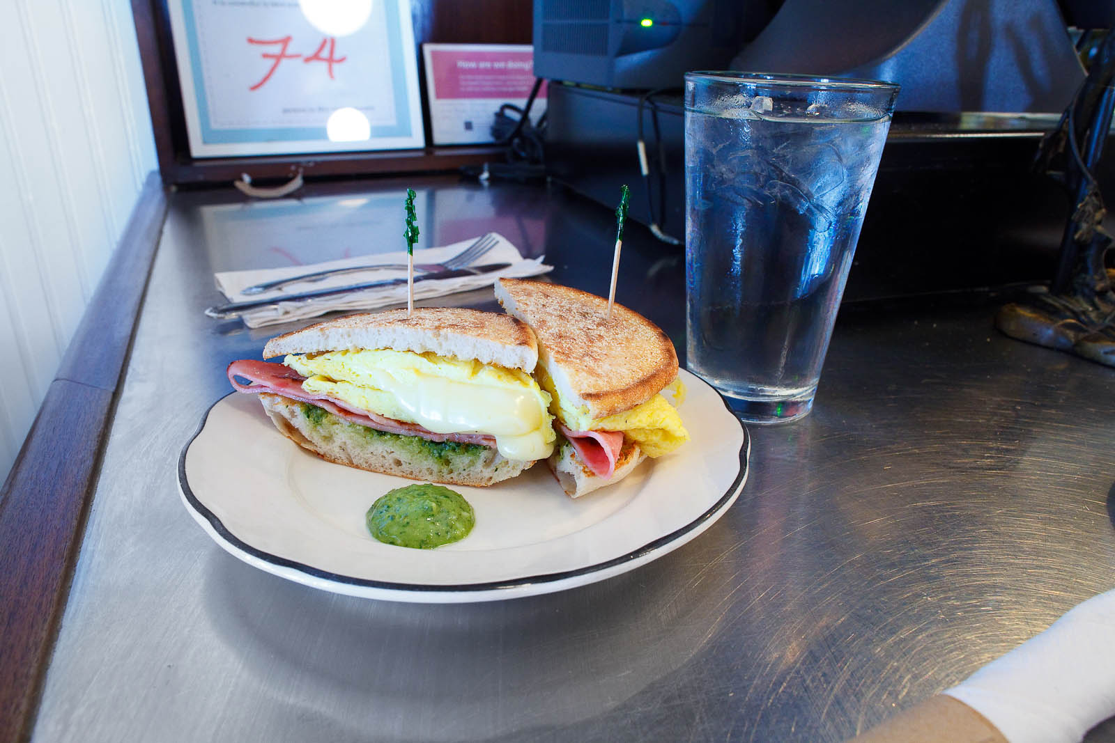 Penny Egg Sandwich - scrambled eggs with american cheese, pesto, and ham on an english muffin ($8)