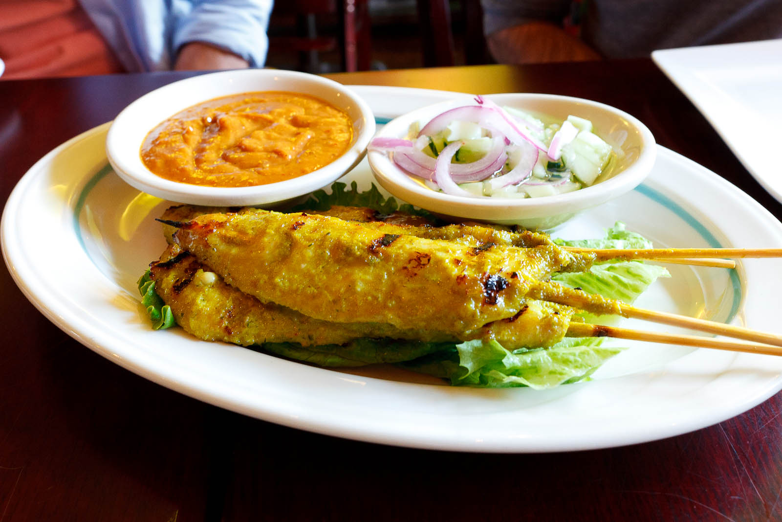 Satay chicken with peanut and cucumber sauce ($7)