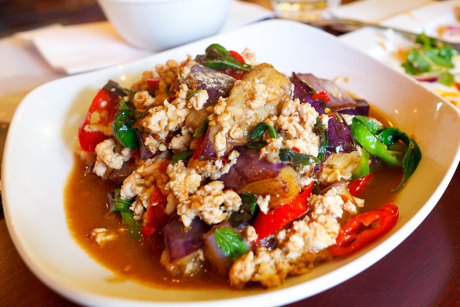Sauteed eggplant with ground chicken, garlic, chili, and basil leaves ($9)