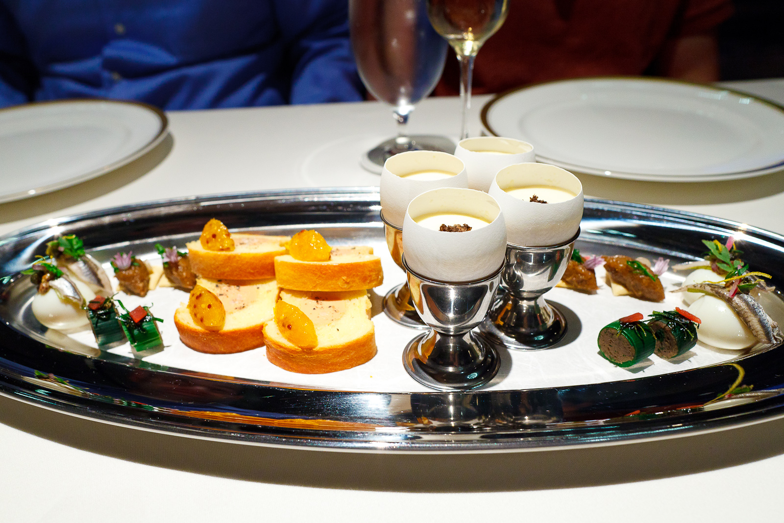 1st Course: Hors d'Oeuvres: quail egg with anchovy, rabbit boudin, leeks stuffed with mushroom duxelles, brioche with foie gras torchon and mustard seed apricot jam, truffled egg