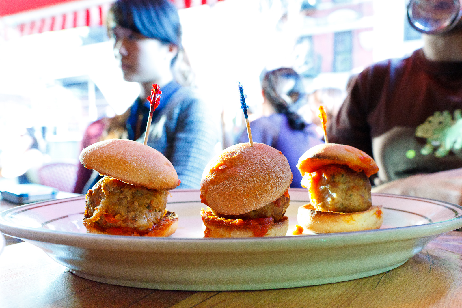 Classic beef, spicy pork, chicken sliders with tomato sauce ($9)