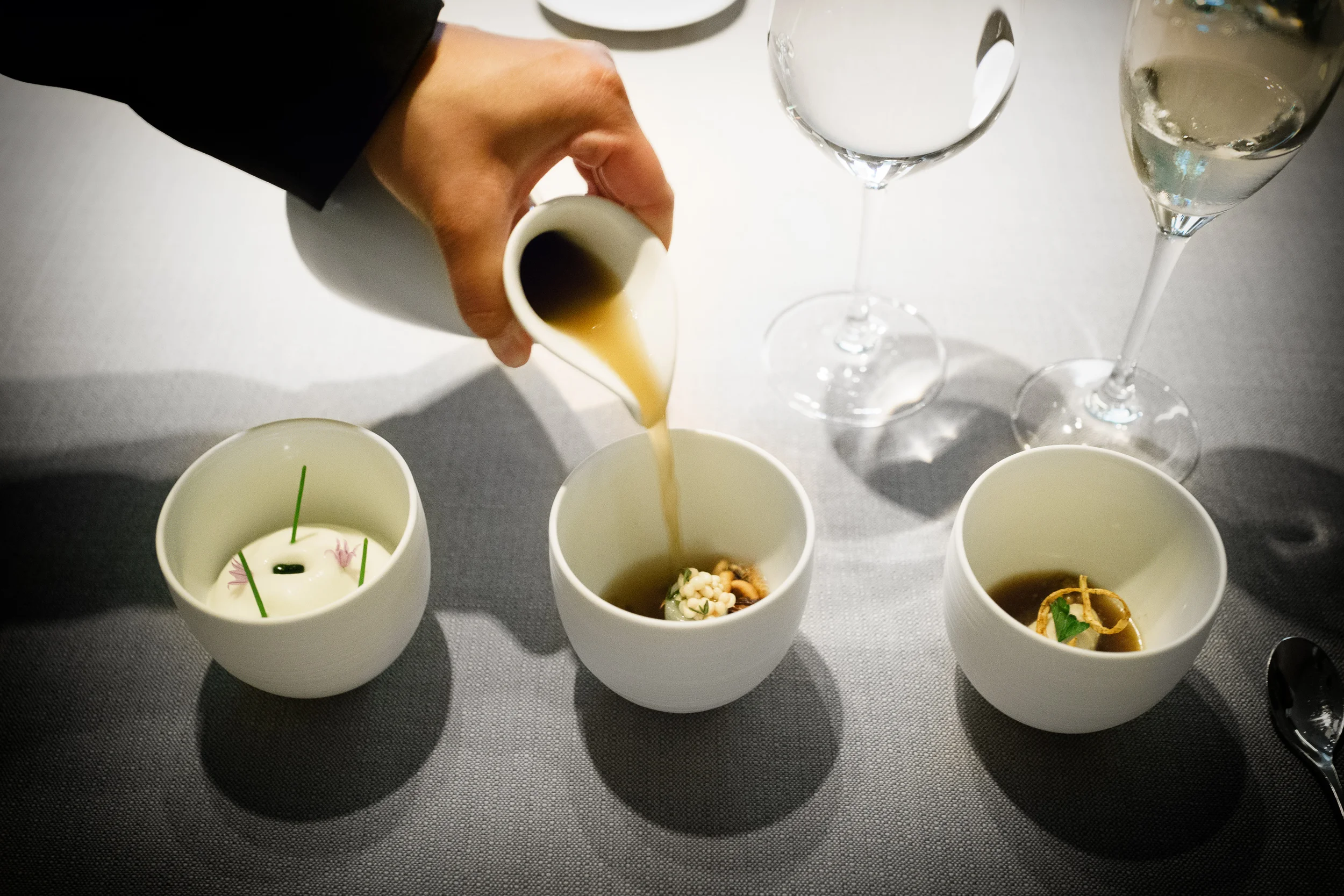Razor clams with whipped cauliflower juice, grilled asparagus broth with pickled okra seeds, artichoke sorbet with chip and consommé