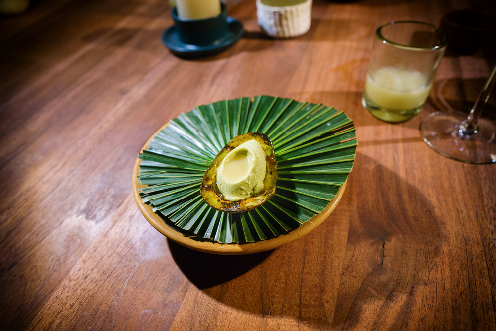 Dessert of grilled avocado and mamey seeds