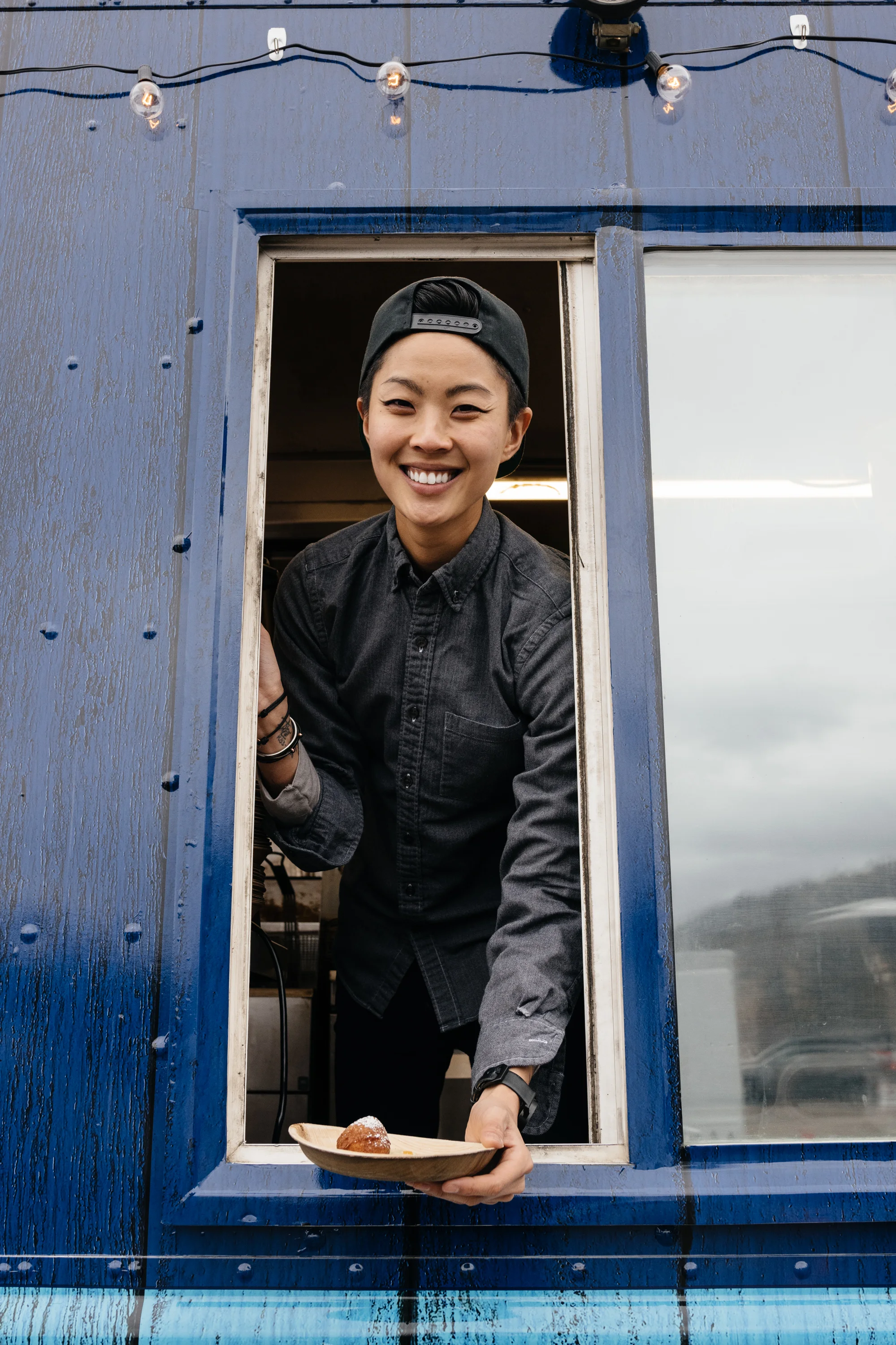 Chef Kristen Kish serving ricotta donuts from inside her food truck at Sundance Film Festival.