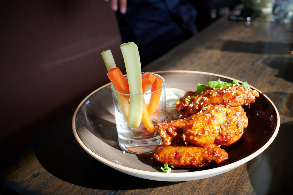 Chicken Wings with Sweet Chili Ginger, Sesame, Cilantro, Carrots, Celery, Buttermilk Cucumber Yogurt at The Farm