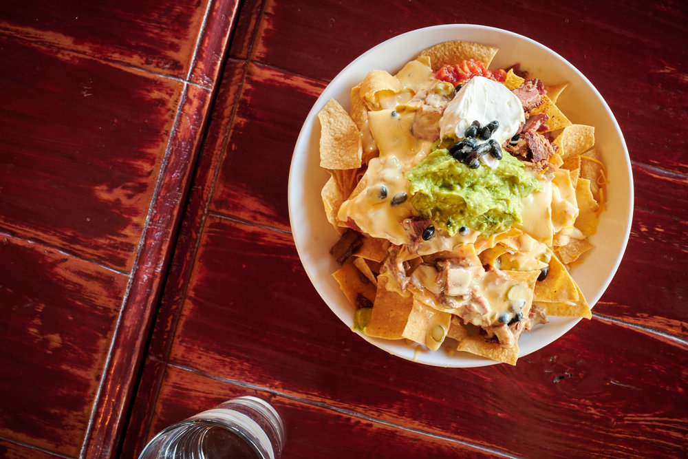 Brisket Nachos, Black Beans, Pico de Gallo, Serrano Cheese, Guacamole, Sour Cream at Red Tail Grill