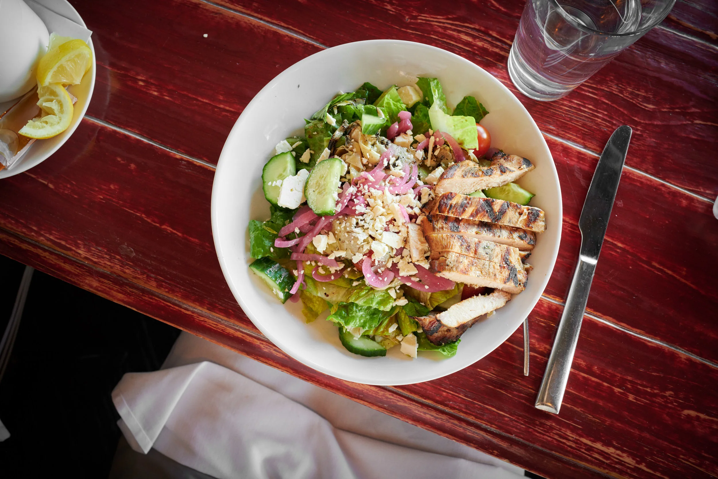 Greek Chop Salad, Chopped Romaine, Grilled Artichoke, Tomato, Pickled Onions, Cucumber, Feta Cheese, Balsamic Vinaigrette