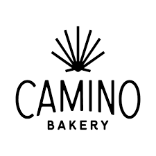 Logo of Camino Bakery featuring a stylized sunburst design above the bakery name.
