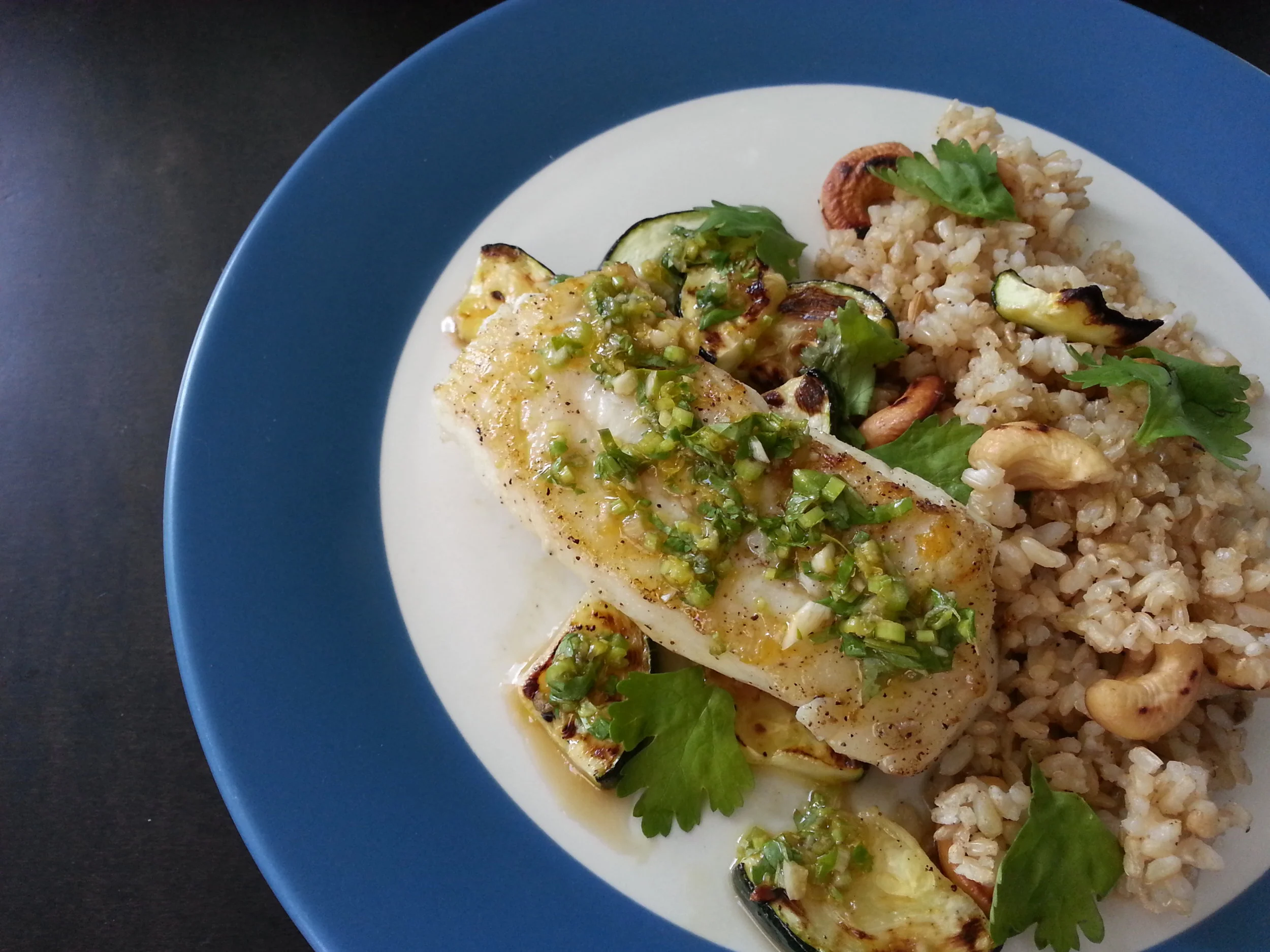 pacific cod with green sauce cashew rice, zucchini, cilantro, lime