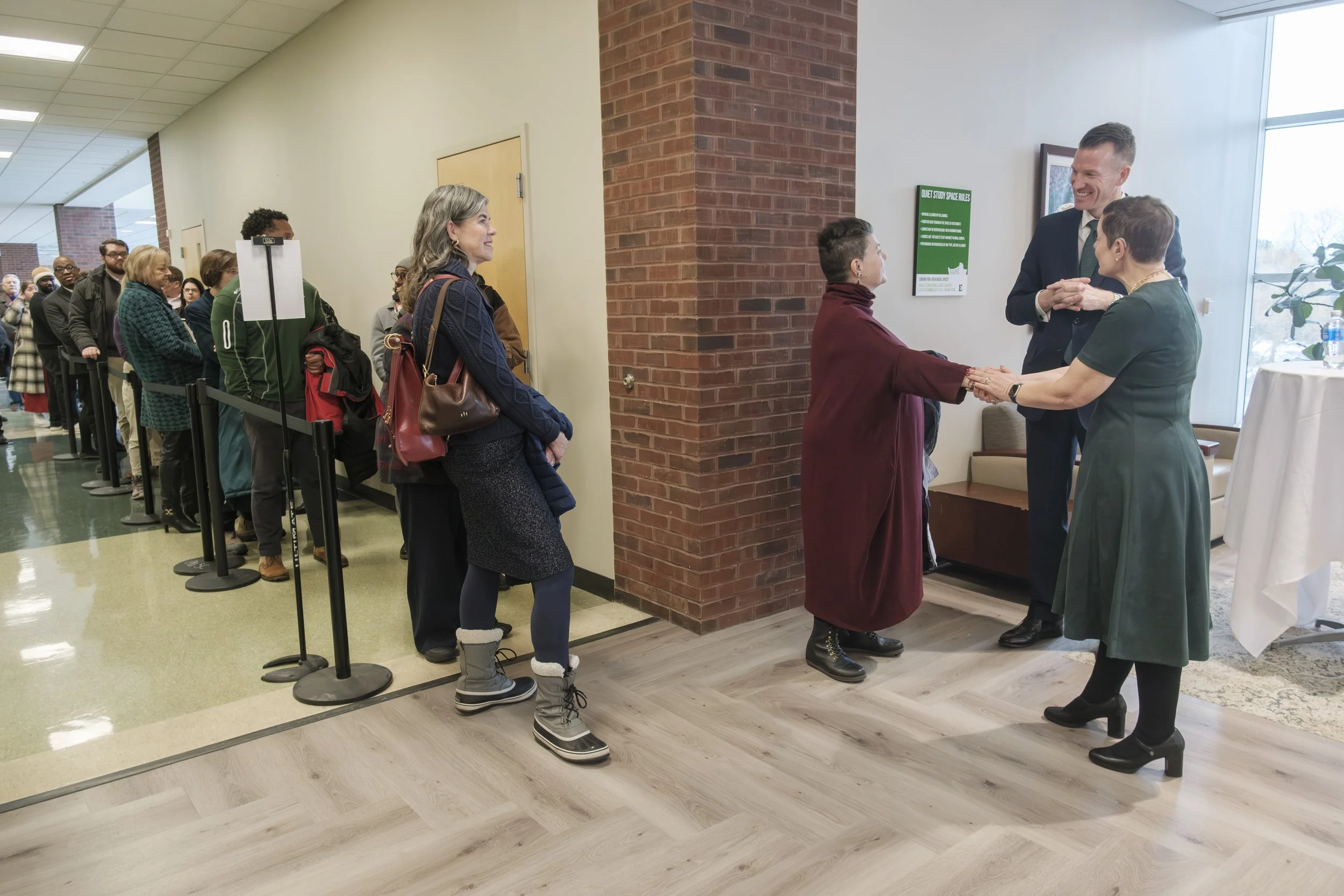 A photo documenting a line of student, faculty and staff lining up to meet Dr. Brendan Kelly and Dr. Tressa Kelly at the Student Center on the campus of Eastern Michigan University.