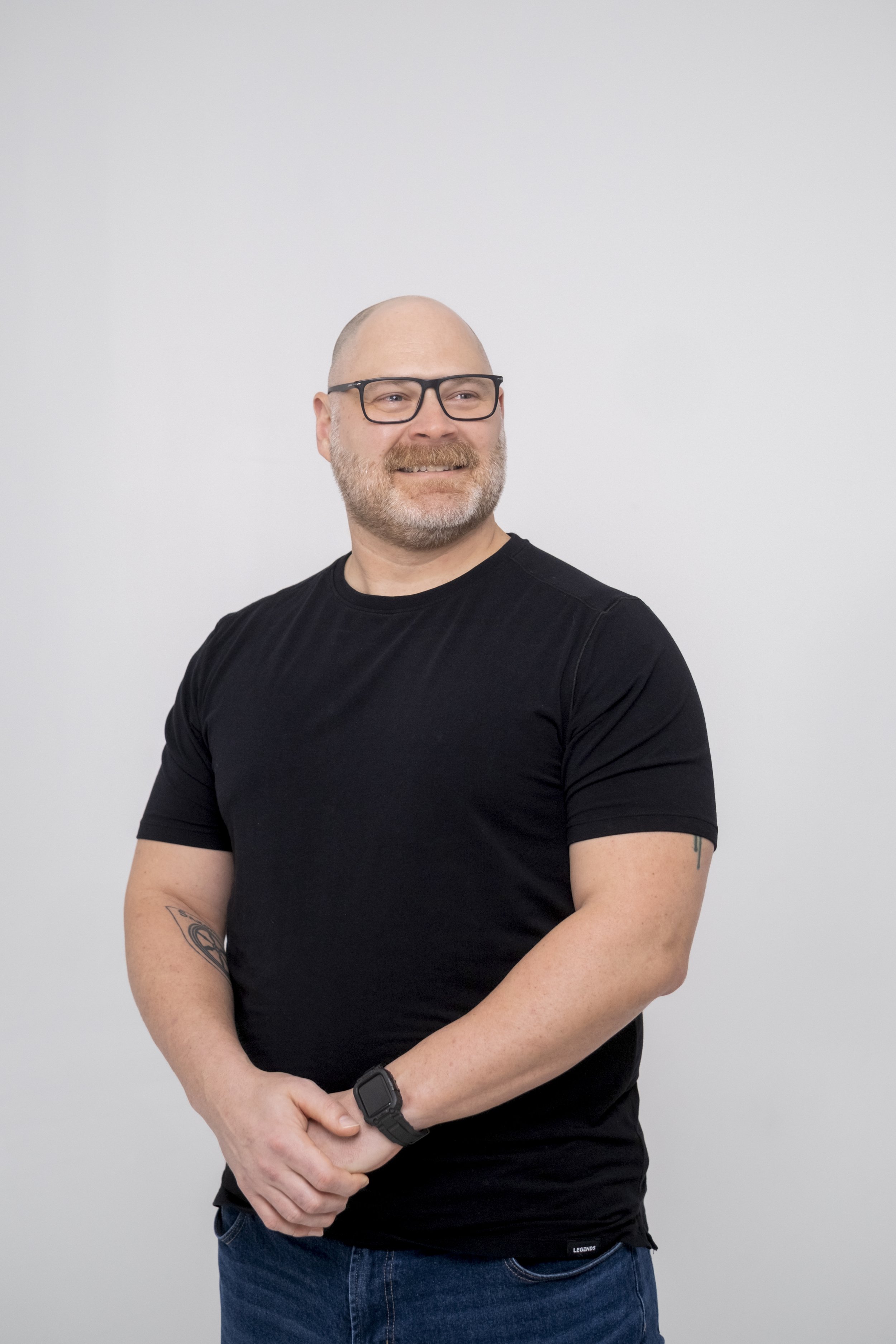 A candid portrait of a man wearing glasses at StudioStudio, a studio space in Ann Arbor, Michigan