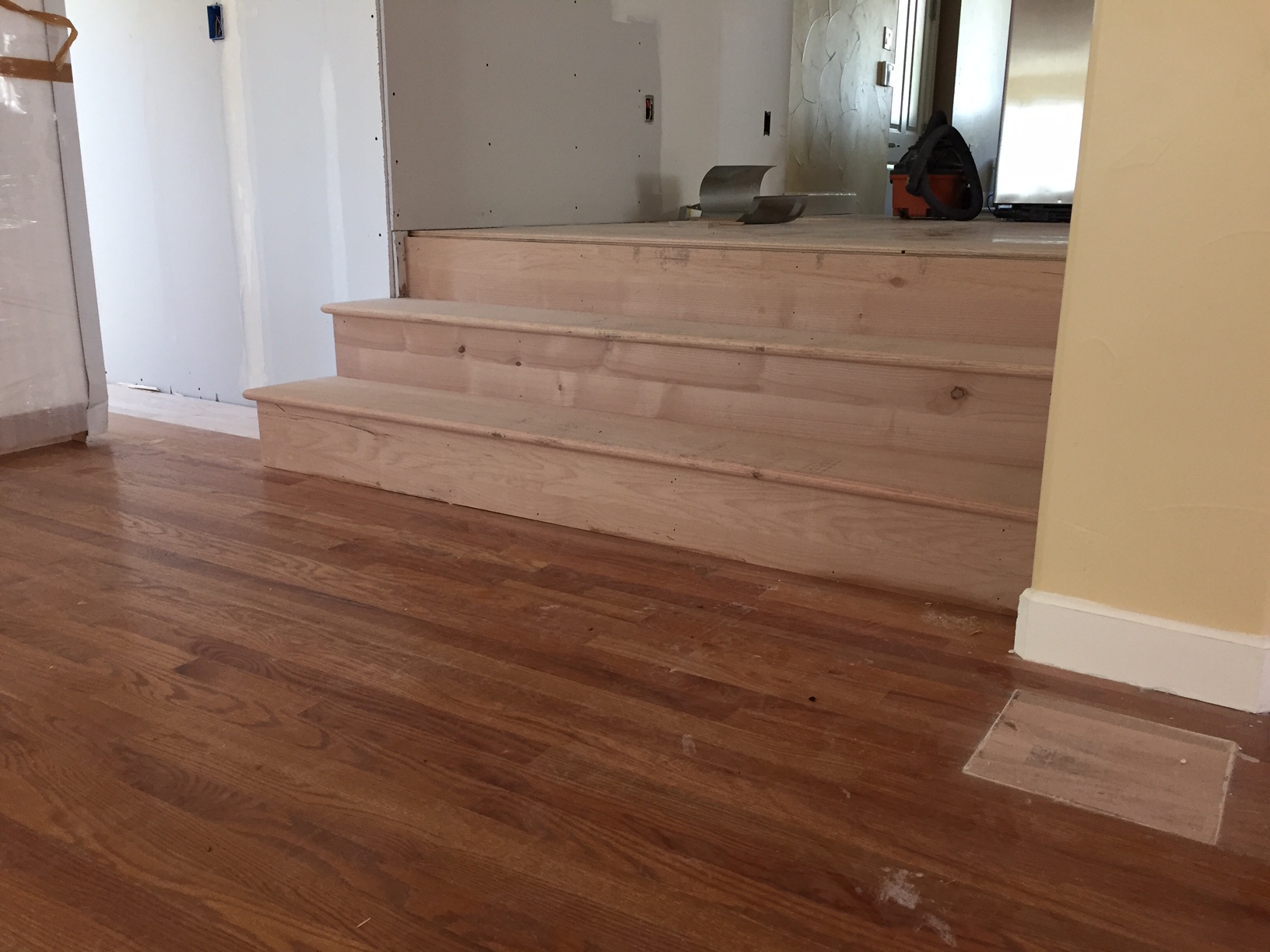 The new entryway between dining room and kitchen was created. These are the new stairs between the two spaces. 
