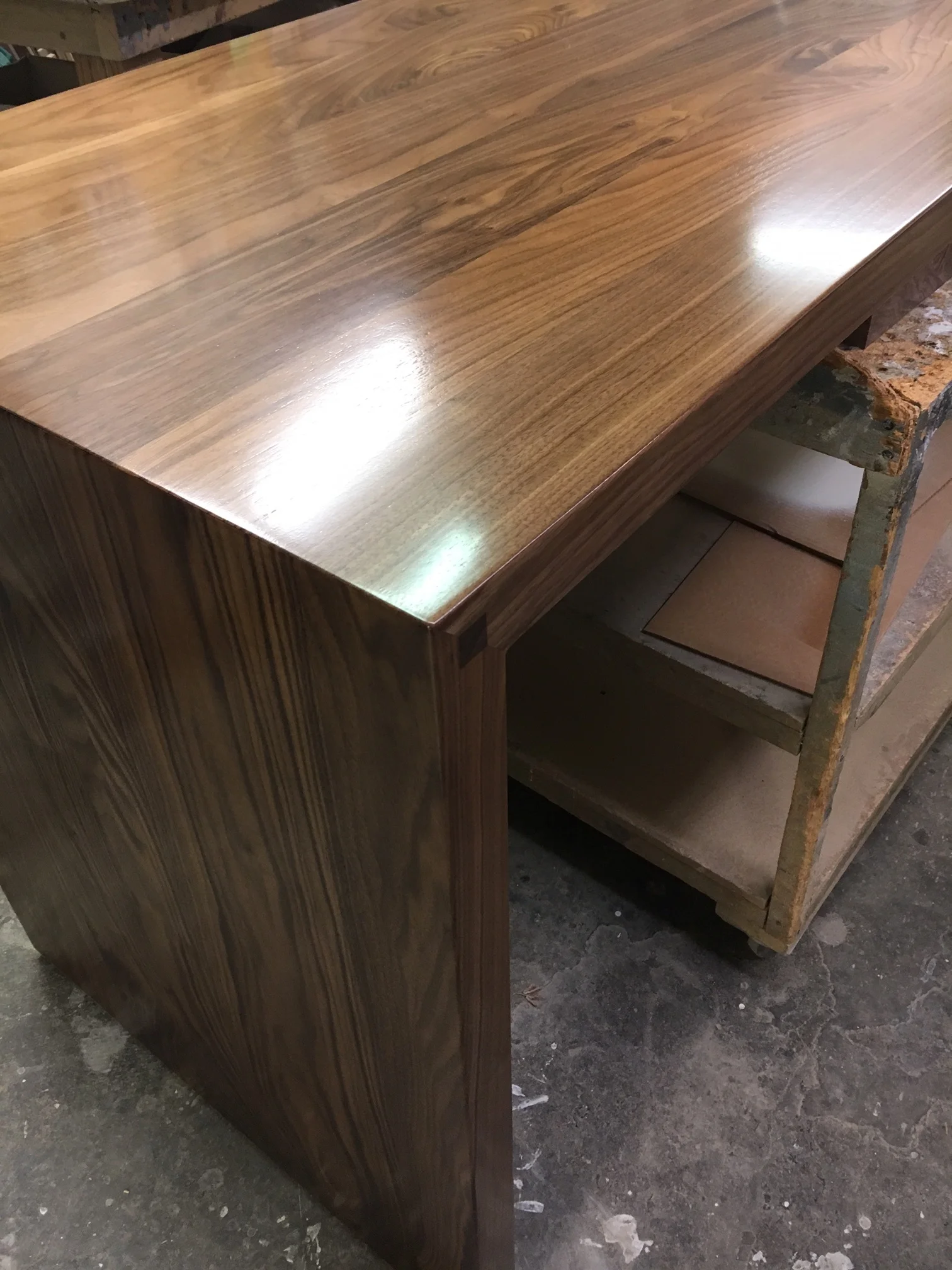 Here is a shot of a custom 2" thick solid black walnut countertop that our local craftsman made for us. It's now installed as a "swing off" on the island. Picture below...