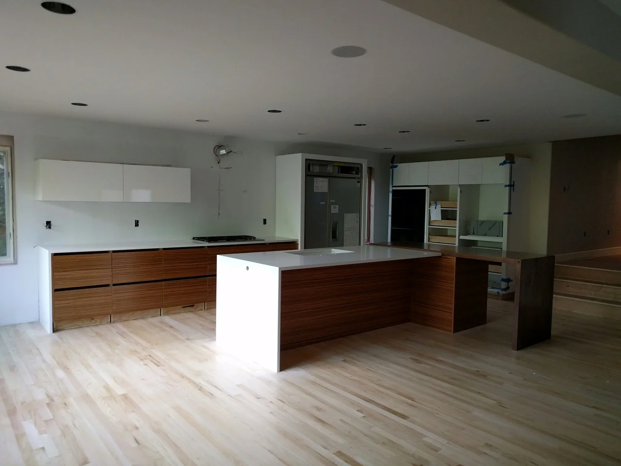 The kitchen is nearing completion. Next up: white backpainted tempered glass backsplash (large panels), appliance paneling, plumbing and electrical trim...