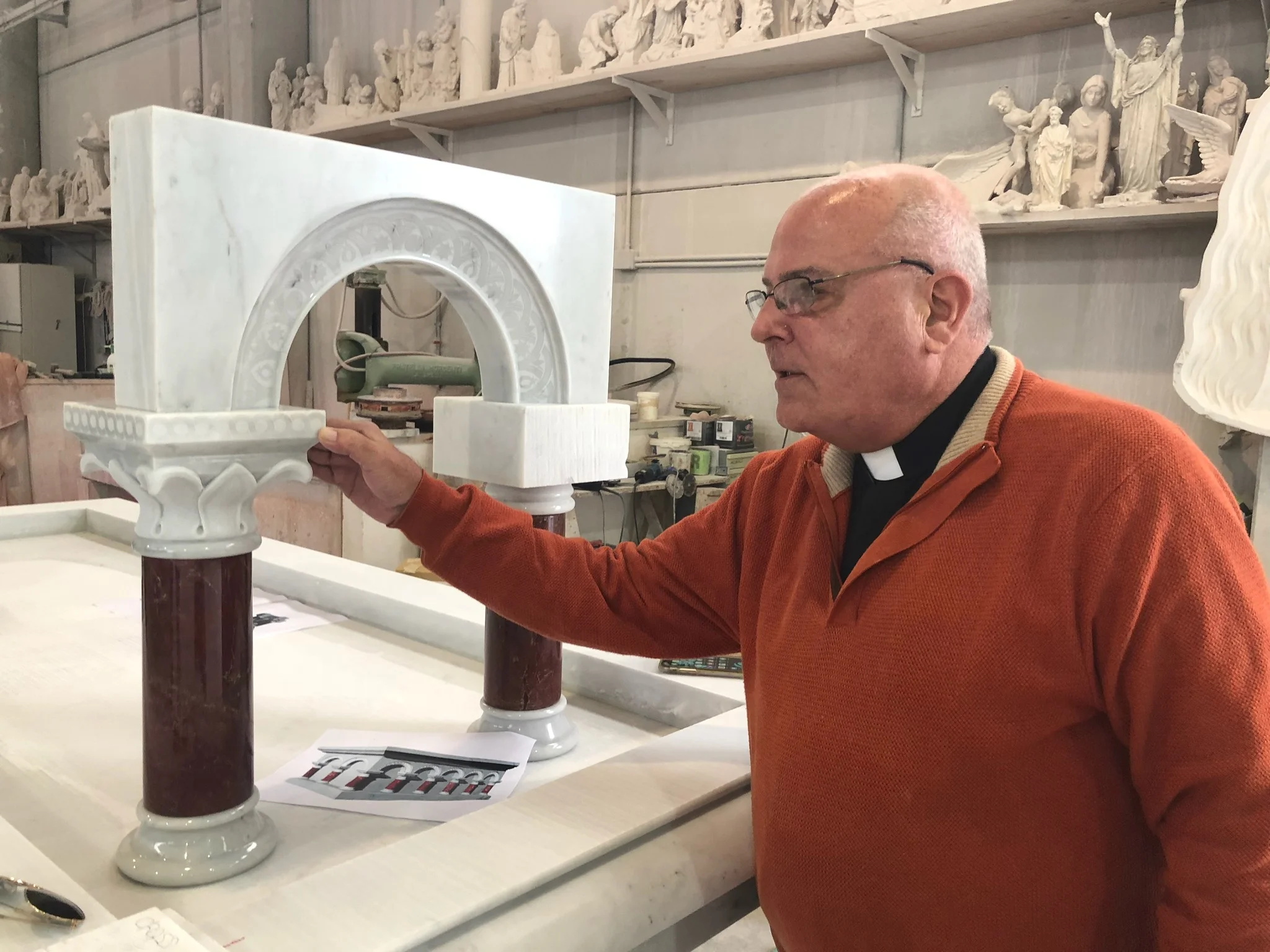 Father Barranger inspecting the carvings for the altar columns at the studio in Pietrasanta, Italy.