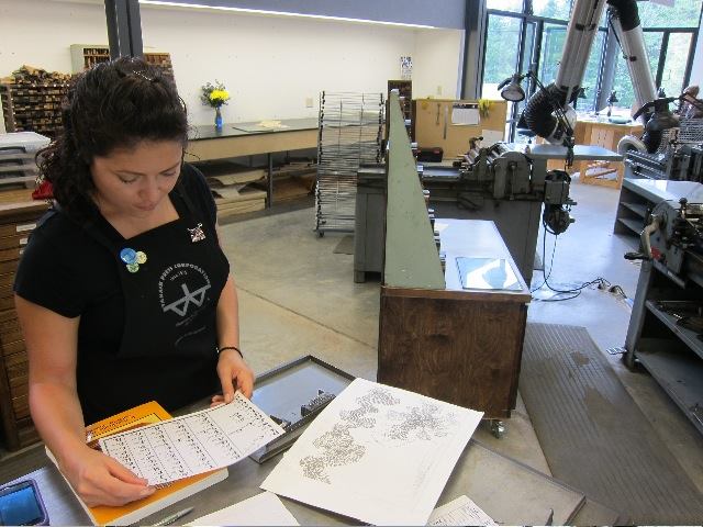 Setting type for the print at Penland School of Crafts, 2013. Photo credit: Emily Arthur