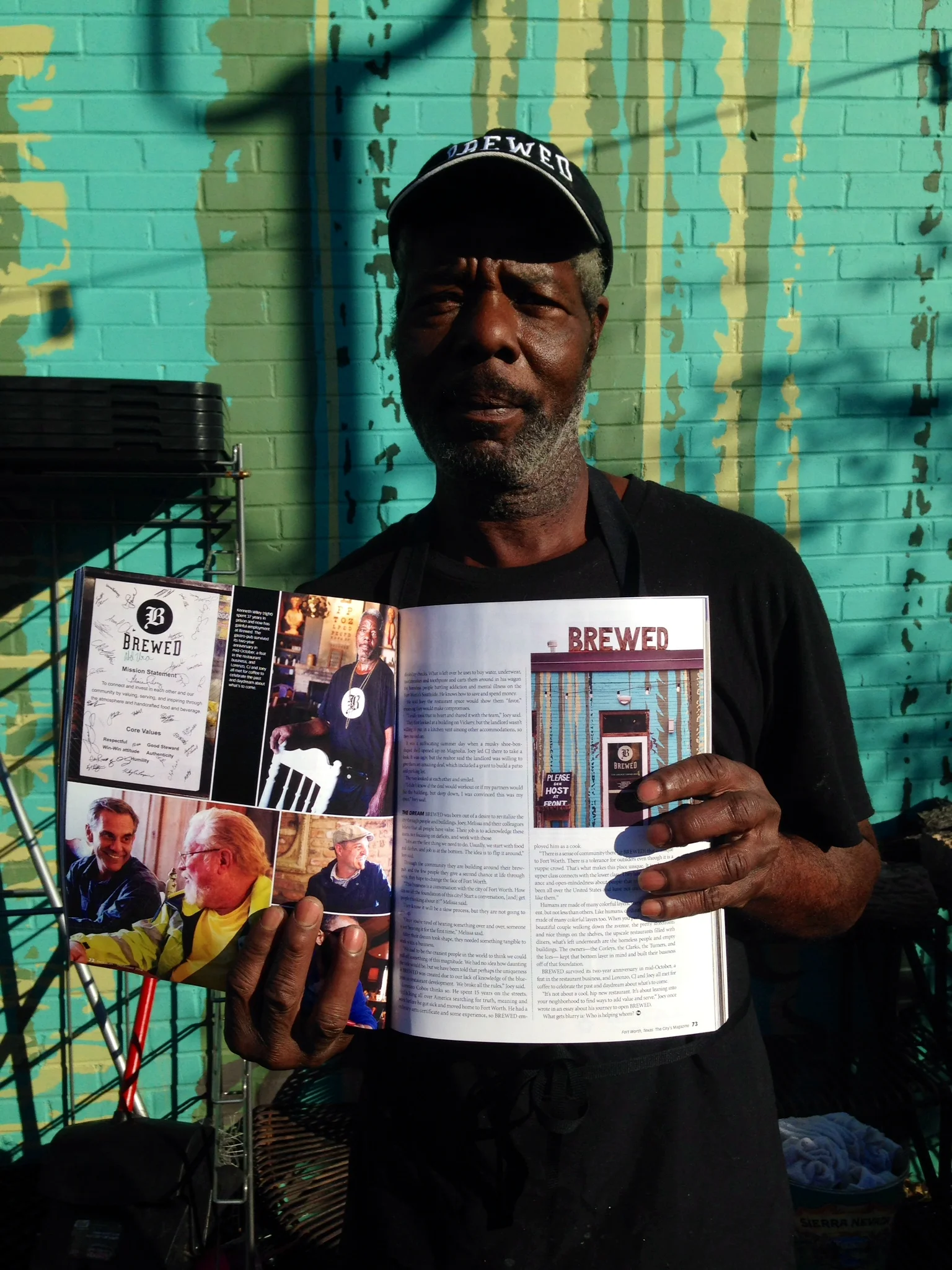 Kenneth Wiley proudly holding up his copy of Fort Worth Magazine.
