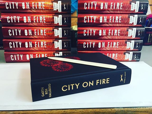 Preparing for our event with Garth Risk Hallberg for City on Fire tonight!! I'm putting the protective Mylar on the jacket. His is our November selection. Thank you @penguinrandomhouse @aaknopf for the beautiful books!