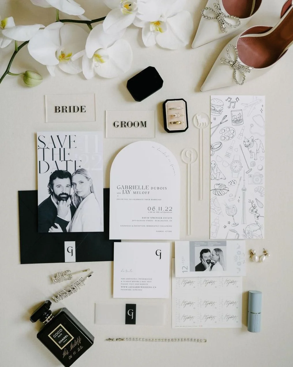 Wedding invitation suite with ring box, perfume, shoes, flowers, and accessories.