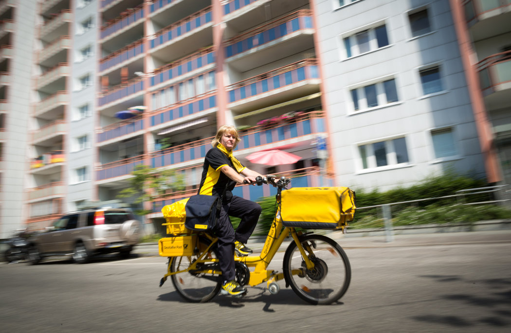 Iris Marossek of Deutsche Post, the German mail service, delivers mail to 1,500 people a day with the assistance of an e-bike. Credit Gordon Welters for The New York Times