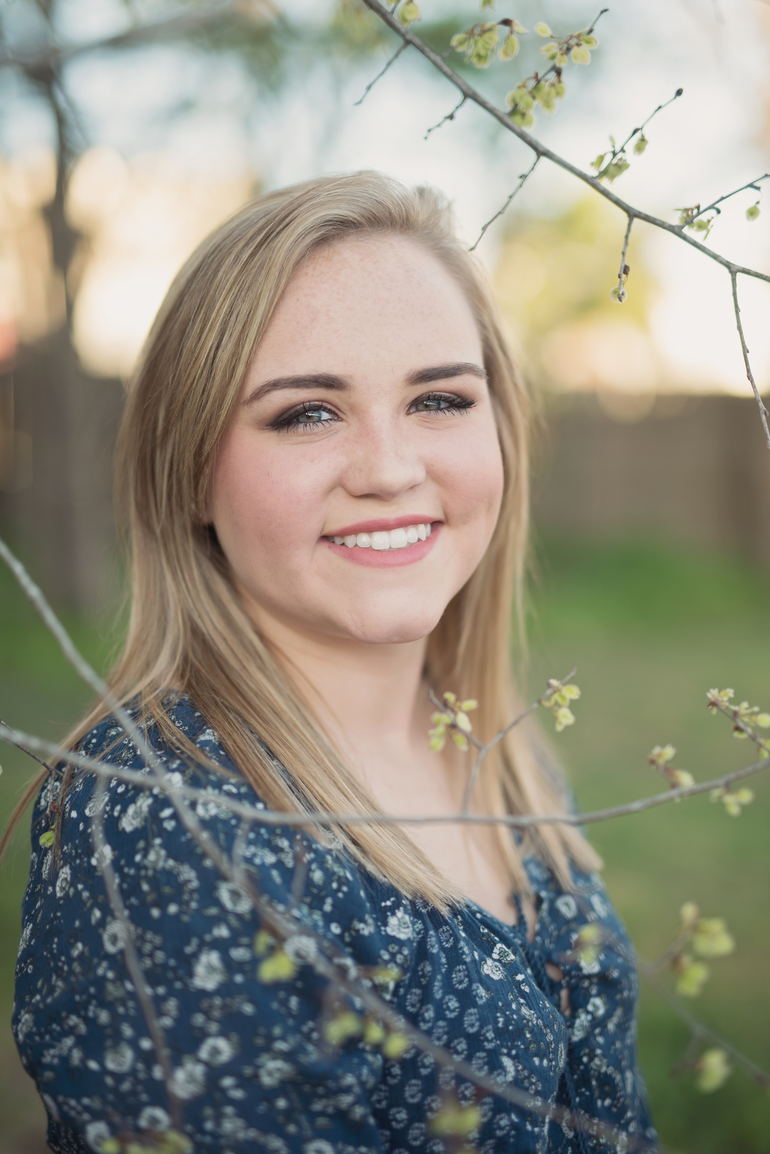 senior portrait girl with simple flowers outdoors