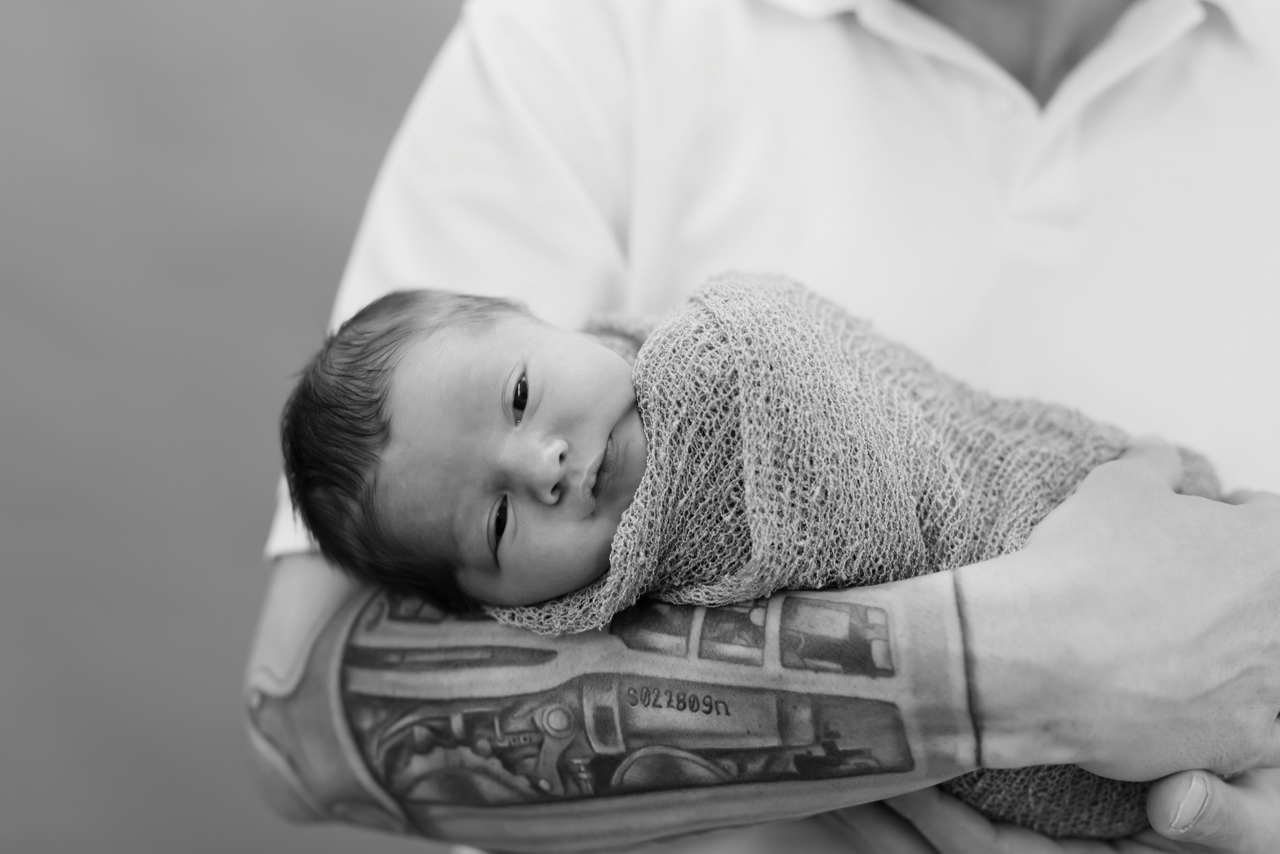 newborn baby with daddy tattoos