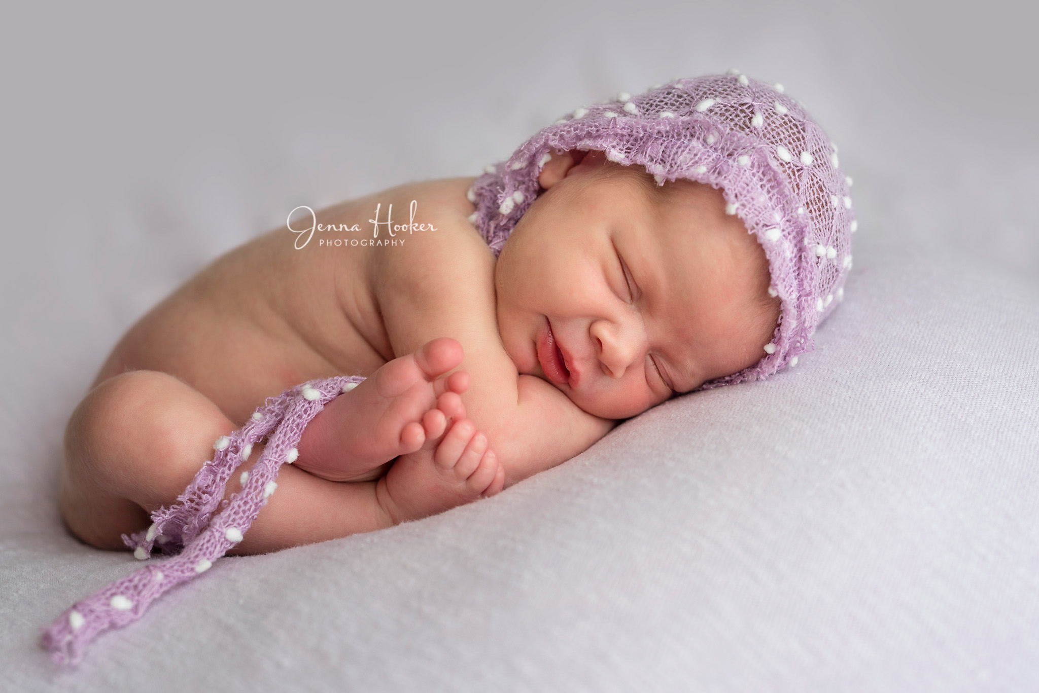 newborn girl with bonnet