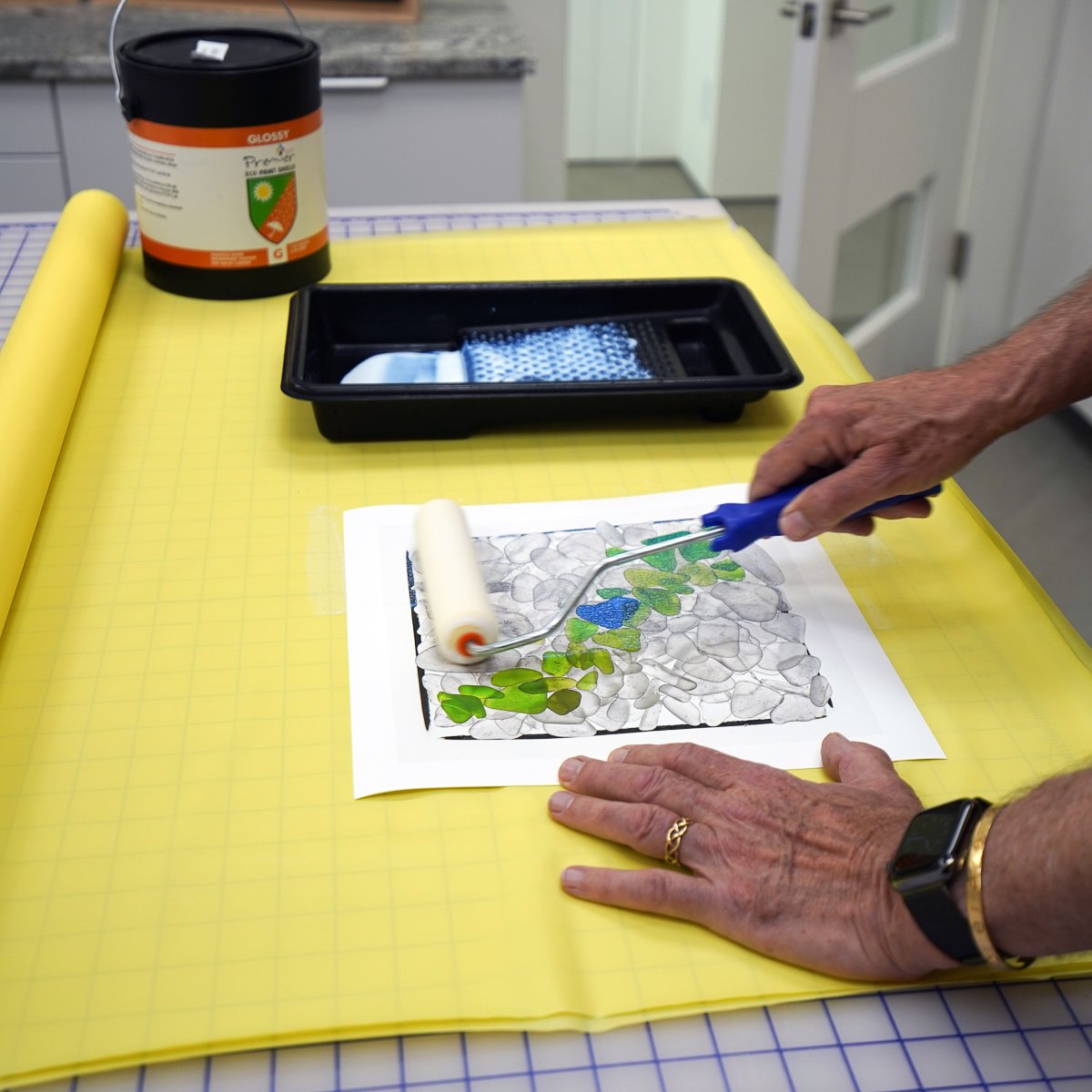  After the print is allowed to dry, usually over night, it’s rolled with three coats of a clear, UV-filtering water based print varnish called Eco Print Shield made by Premier Art Products. Prints get two coats of Glossy Eco (the clearest) and a fina