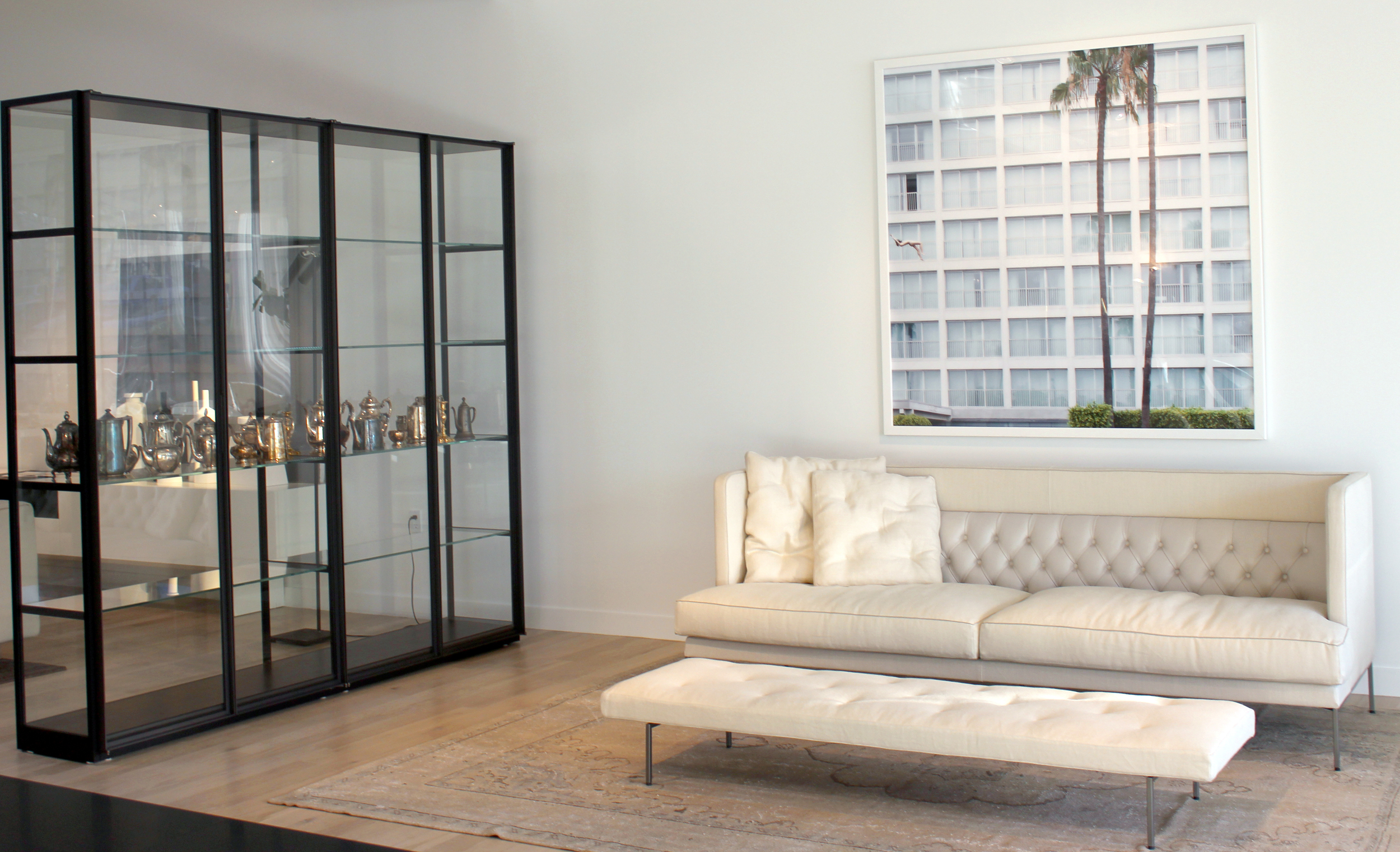 This vignette features the Lipp sofa and bench Living Divani with the Ex-Libris iron and glass display cabinet by Porro, Art by Scarlet Mann. #livingdivani #porro #salvatori #pierolissoni #scarletmann #modern #architects #designers #design #LosAngeles #moderninteriors 