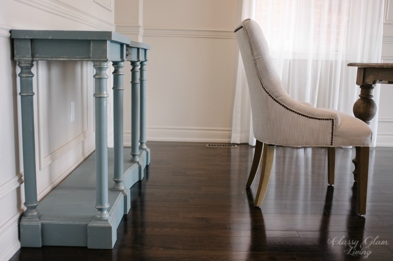 Space between chair and console table.