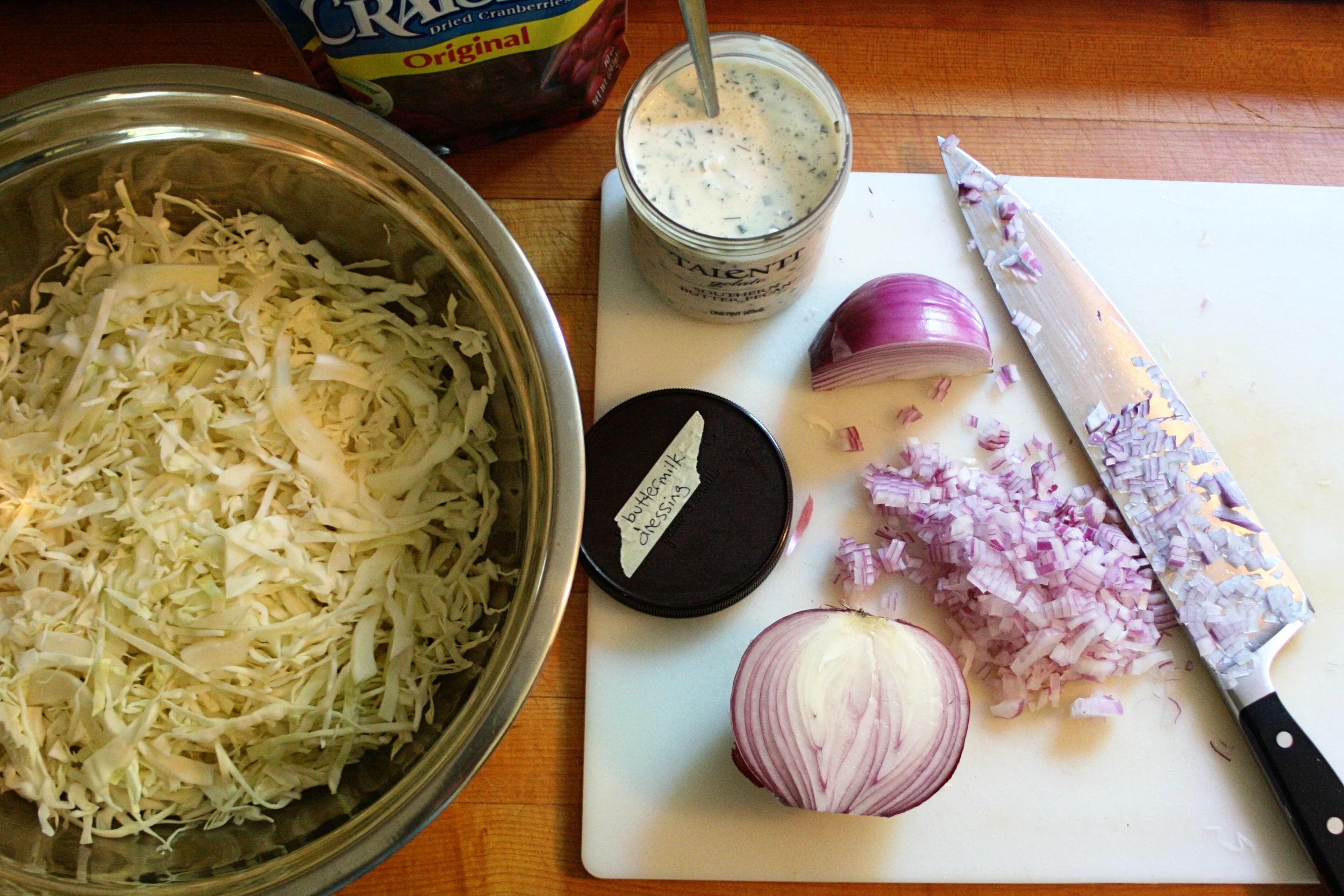 I thinly slice one small or half a large head of cabbage, chop a half of a red onion (somewhat finely), and toss in about a cup of dried cranberries. 