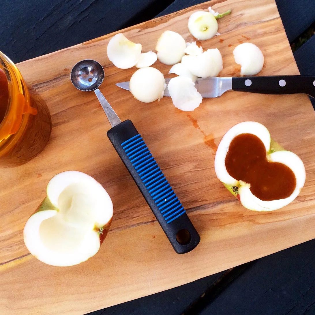 Next, pour barely warmed caramel into the cavity. I set my apple halves in custard cups to keep them level and then placed them in the fridge overnight.