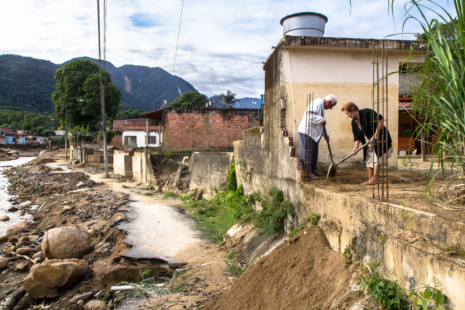 Note the water line above their heads, as they shovel mud out of their old living room.