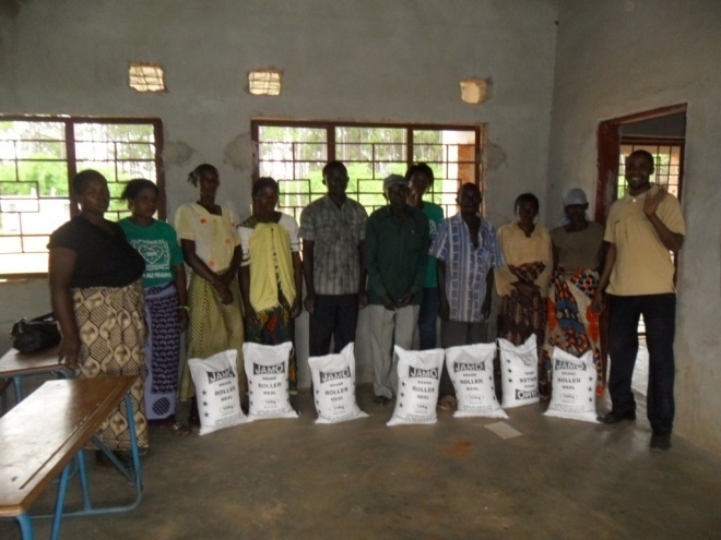 Stanley in a brown T/shirt on the right and the volunteers giving food to TB/HIV/AIDS patients in Mugala community