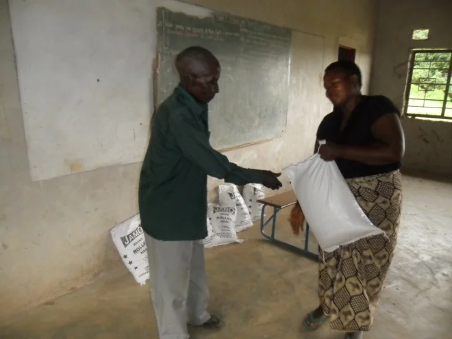 Mrs Mugala giving melie meal to one of our clients in Mugala community