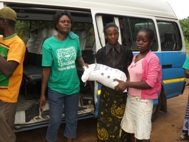 Matilda giving food to Sara in St. Anthony community on February 10th 2012