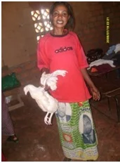 Justina receiving a chicken fro Christian Aid Ministries during the food distribution to the patients in St. Anthony communit