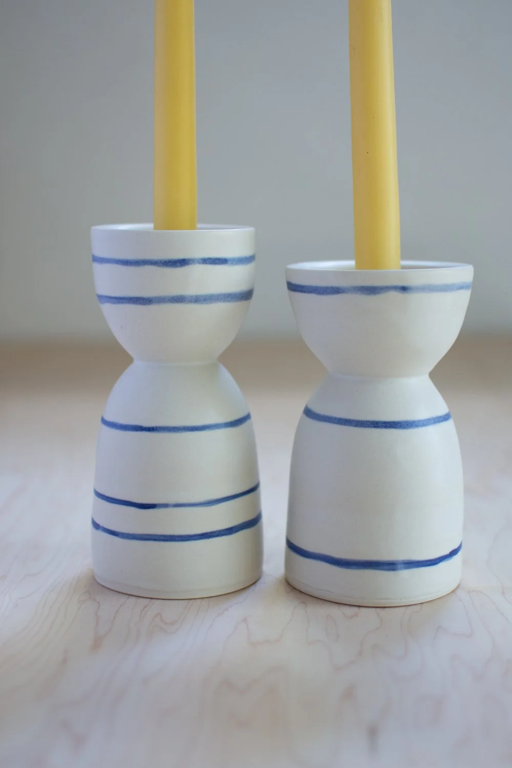 Porcelain candle holder set with blue stripes by Eleanor Annand.