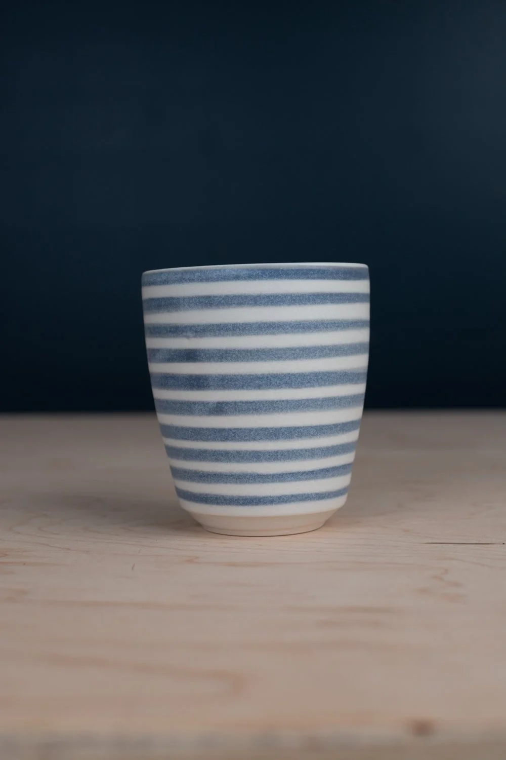 Black and white porcelain mug with hand-painted illustration by Eleanor Annand.