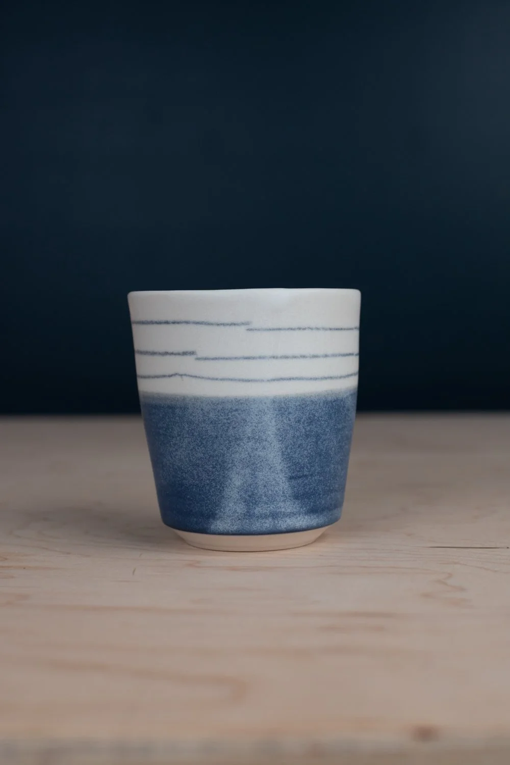 Black and white porcelain mug with hand-painted illustration by Eleanor Annand.